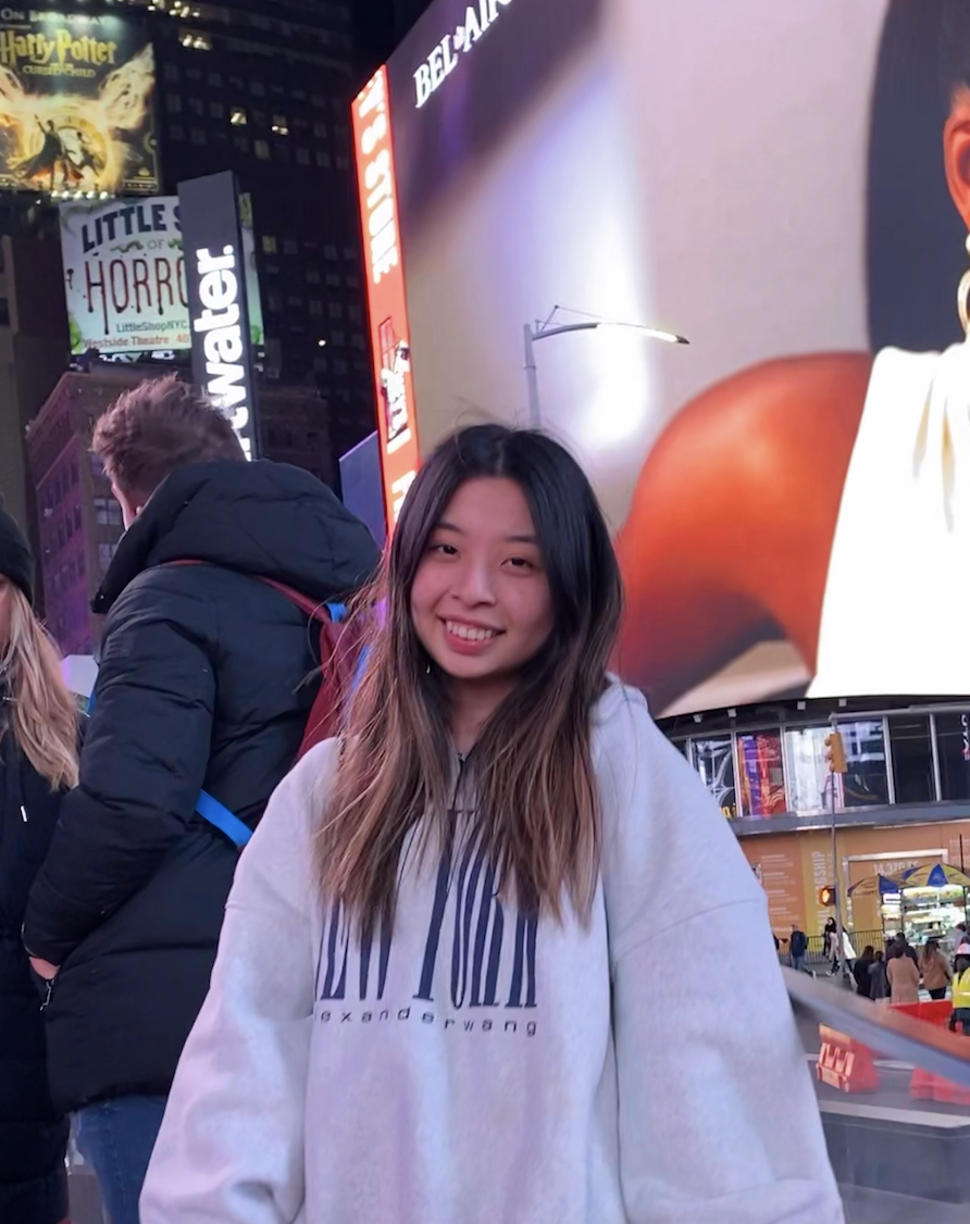 Picture of Serena Gong wearing a sweater with the words New York